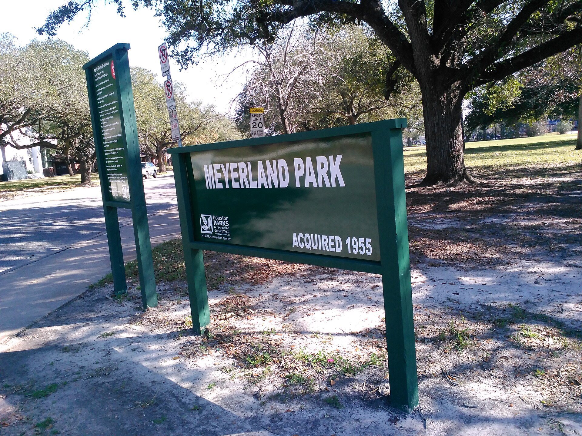 Meyerland Park entrance surrounded by mature trees