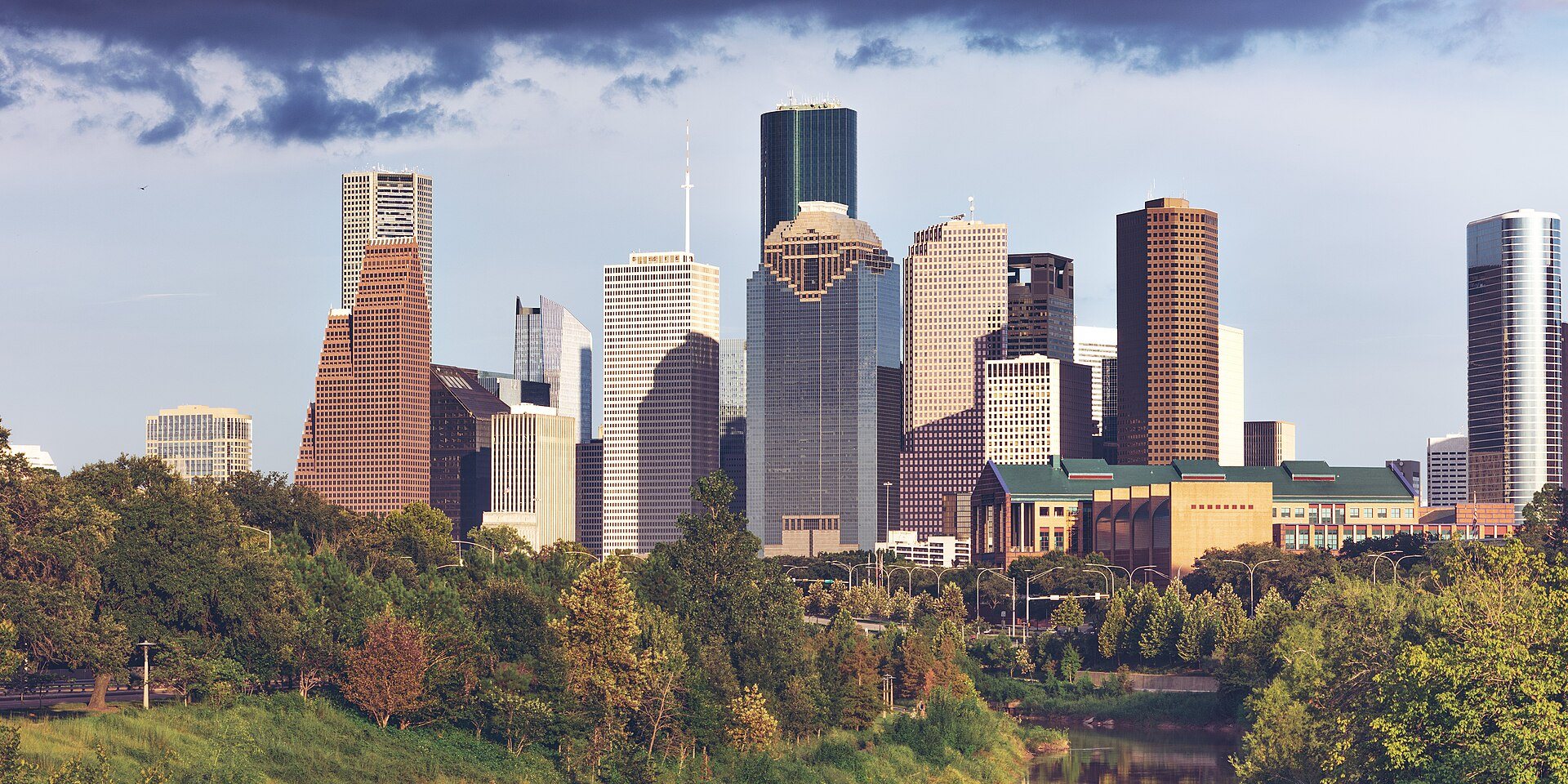 Downtown Houston skyline above Buffalo Bayou's green banks