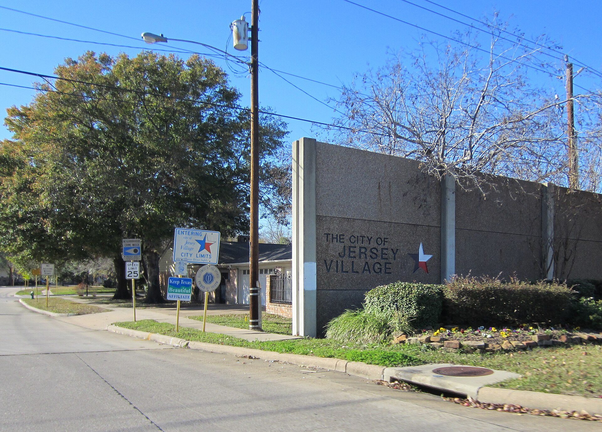 Flags and landscaped entrance to Jersey Village