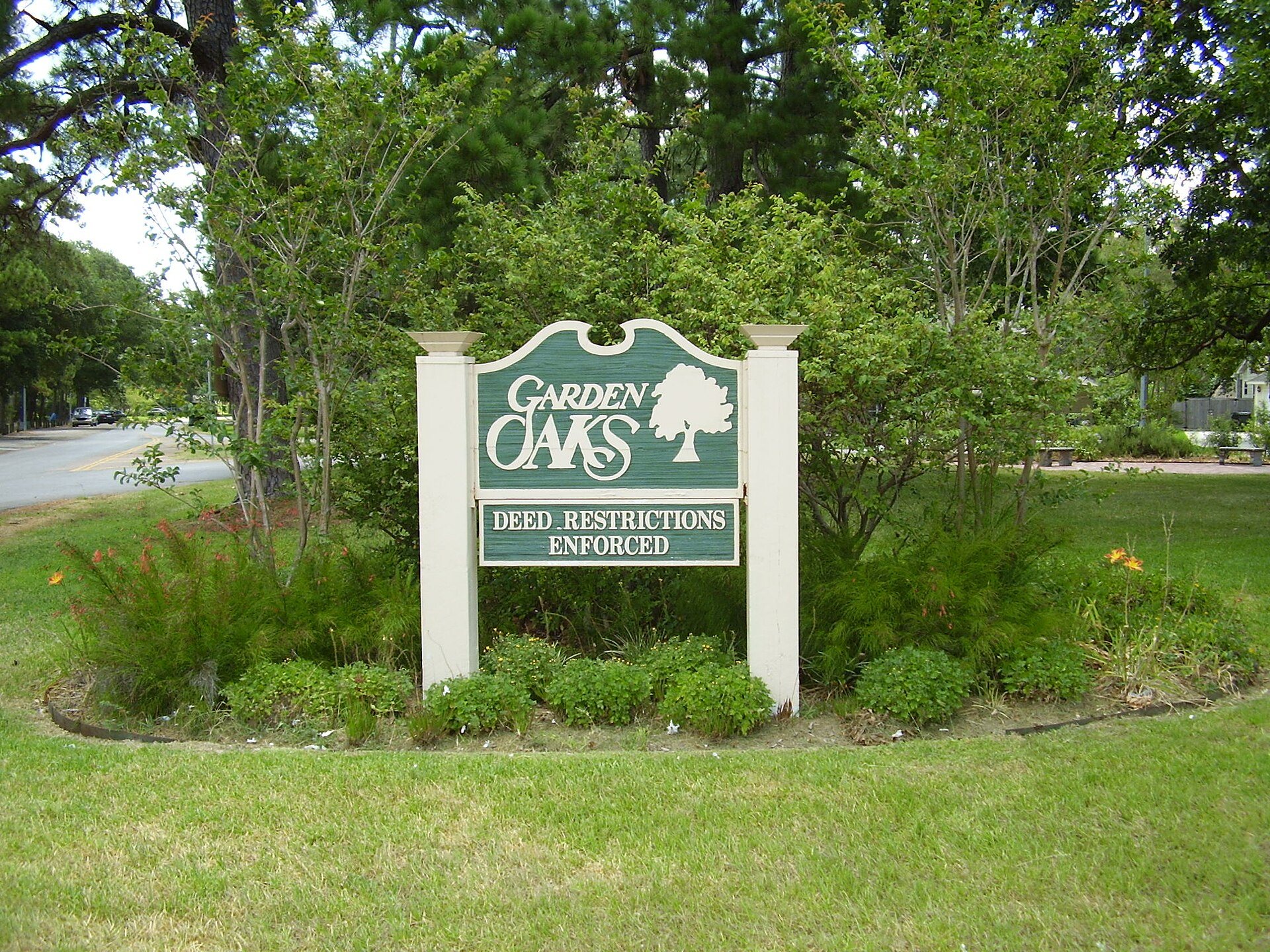 Garden Oaks neighborhood marker beneath mature trees